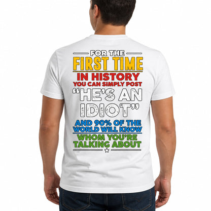 Plain t-shirt with bold typographic text reading "He's an idiot" centered on the chest