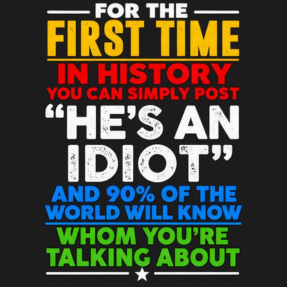 Plain t-shirt with bold typographic text reading "He's an idiot" centered on the chest