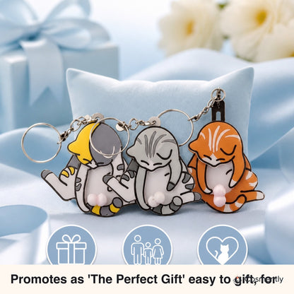 Light gray Mischief Cat keychain clipped to backpack zipper